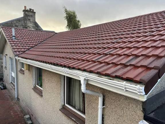 Completed roof replacement on bungalow with new tiles and guttering