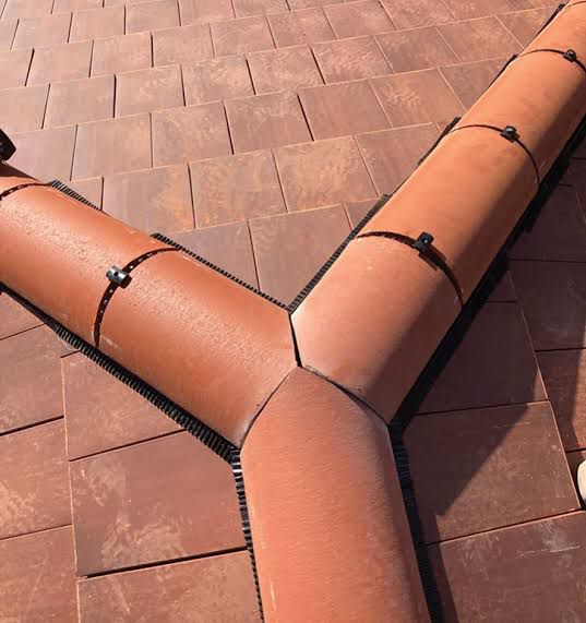 Ridge junction detail with dry ridge system on tiled roof