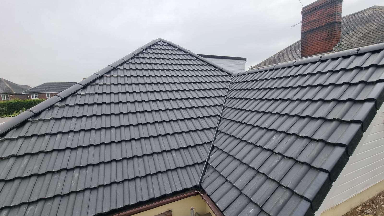 Completed grey concrete tile roof replacement on bungalow
