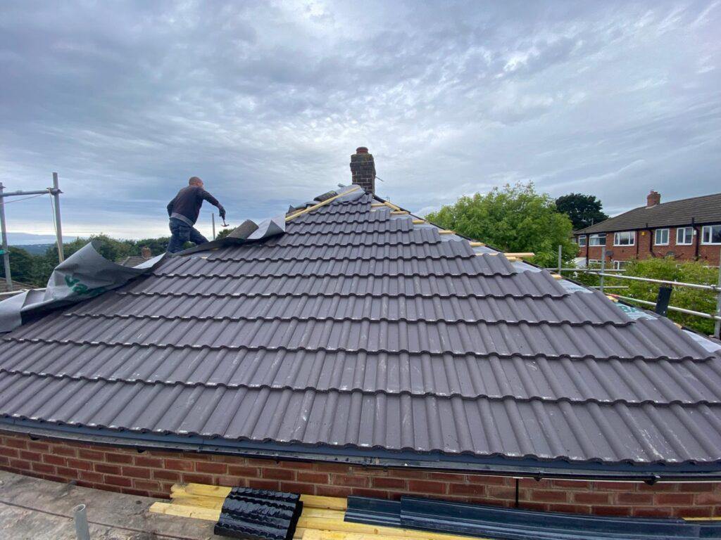 uPVC soffit panel being fitted under roof overhang for ventilation