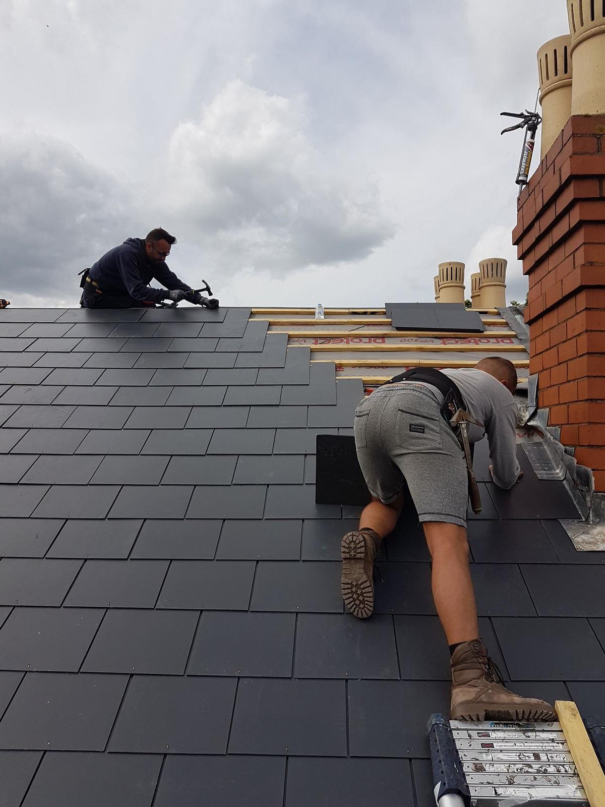 Experienced roofer installing tiles on a residential roof in County Durham