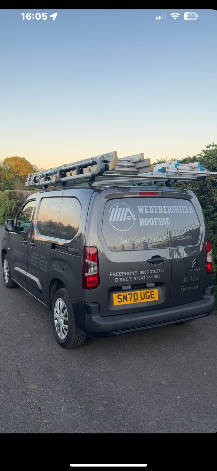Professional roofer installing tiles on a residential property